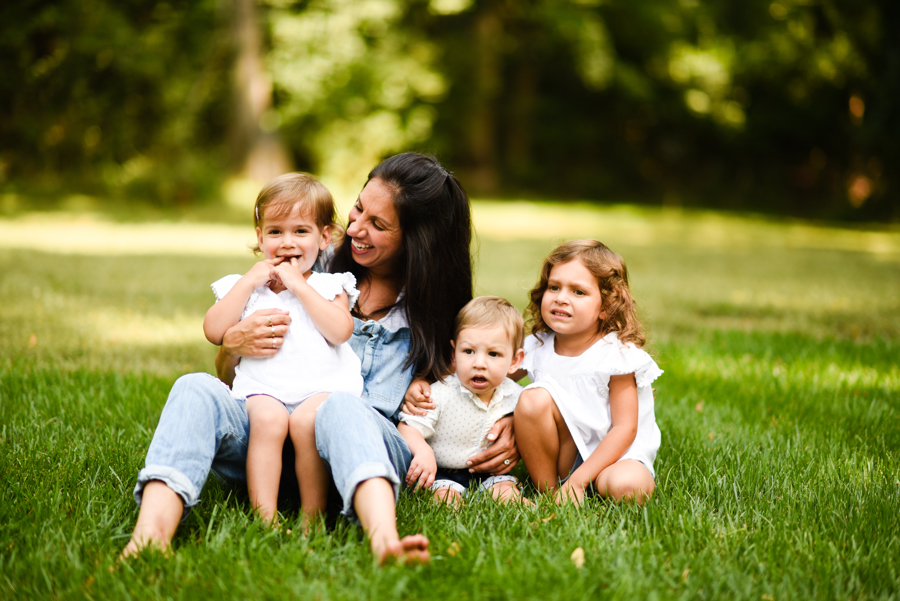 woman laughing with 3 kids