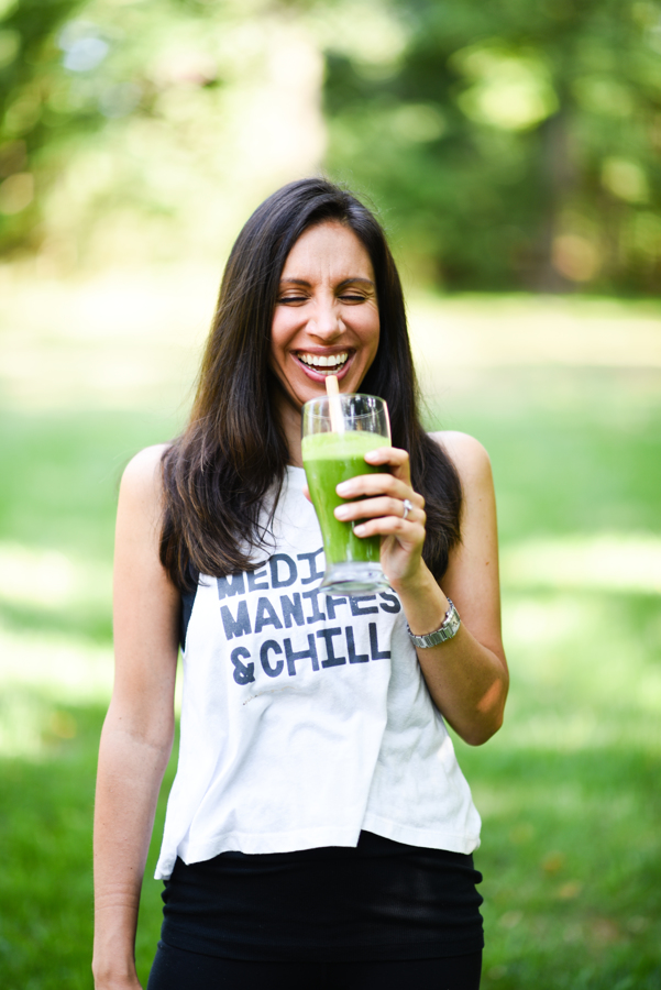 laughing while drinking green juice