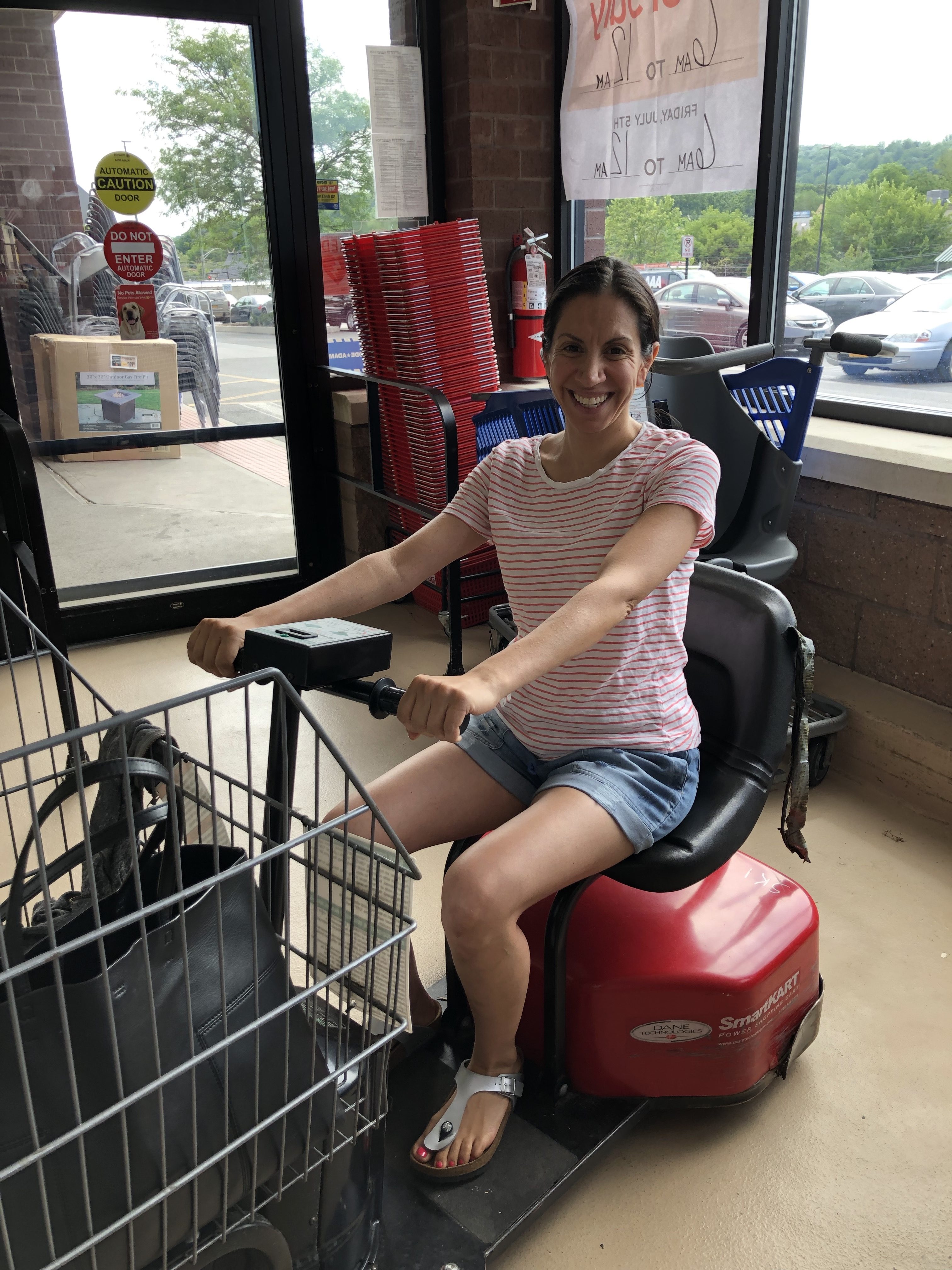 woman in a motorized grocery cart