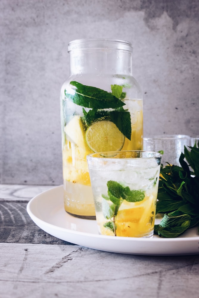 water with lemon and mint in glass carafe and glass