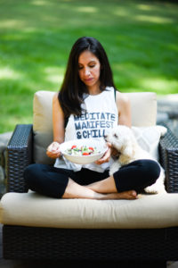 woman eating salad with dog