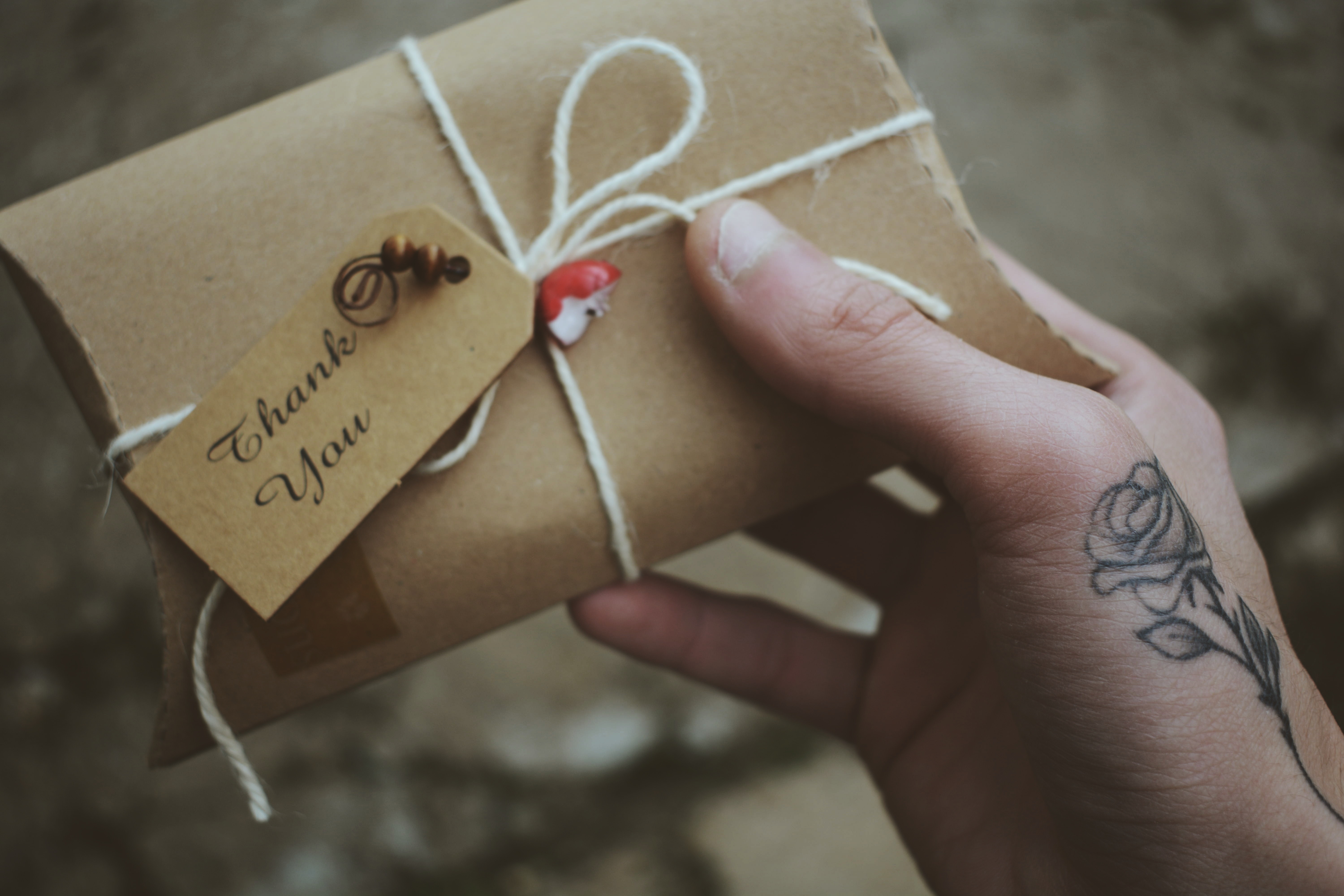 package wrapped in brown paper that says "Thank you"