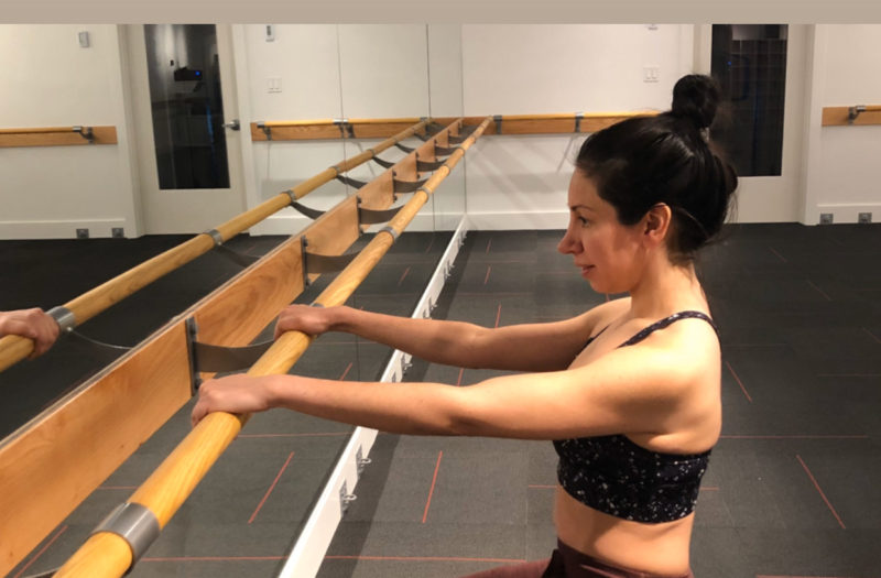 Woman sitting in barre class