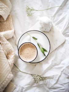 bed with tea and blanket