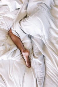 person sleeping with leg sticking out