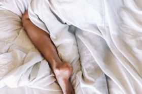 person sleeping with leg sticking out