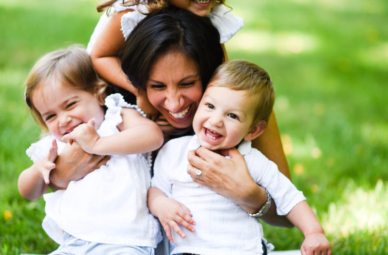 woman with 3 kids laughing