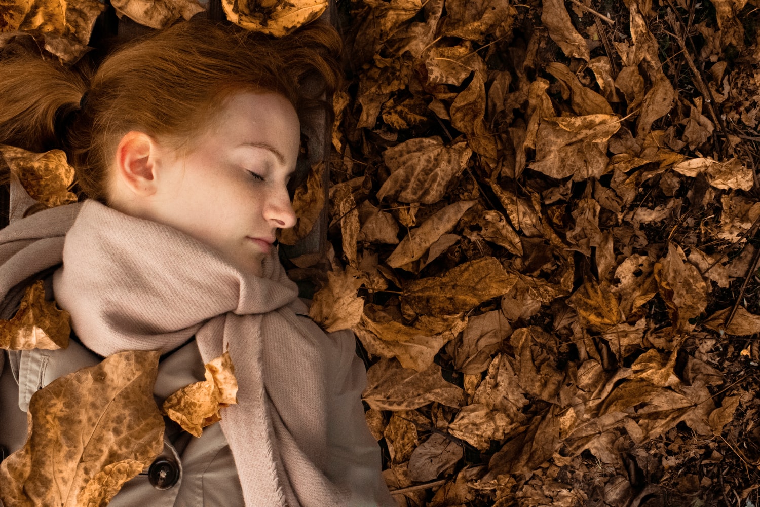 woman sleeping in leaves